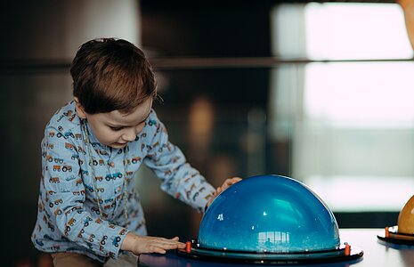 Young visitor enjoying the exhibition at the ESO Supernova